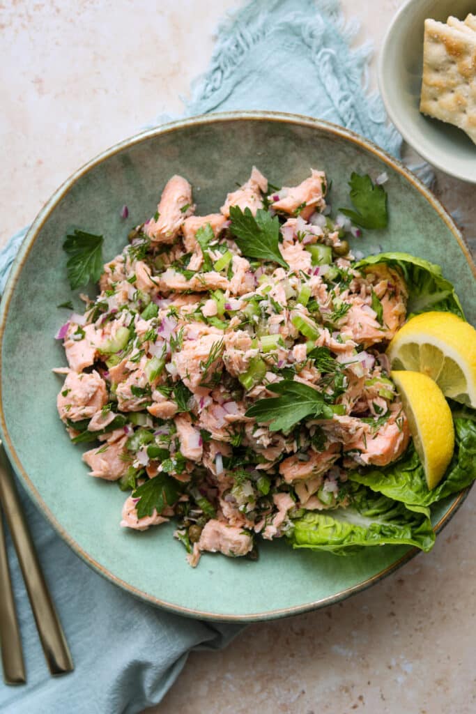 easy chilled poached salmon salad in green plate with crackers