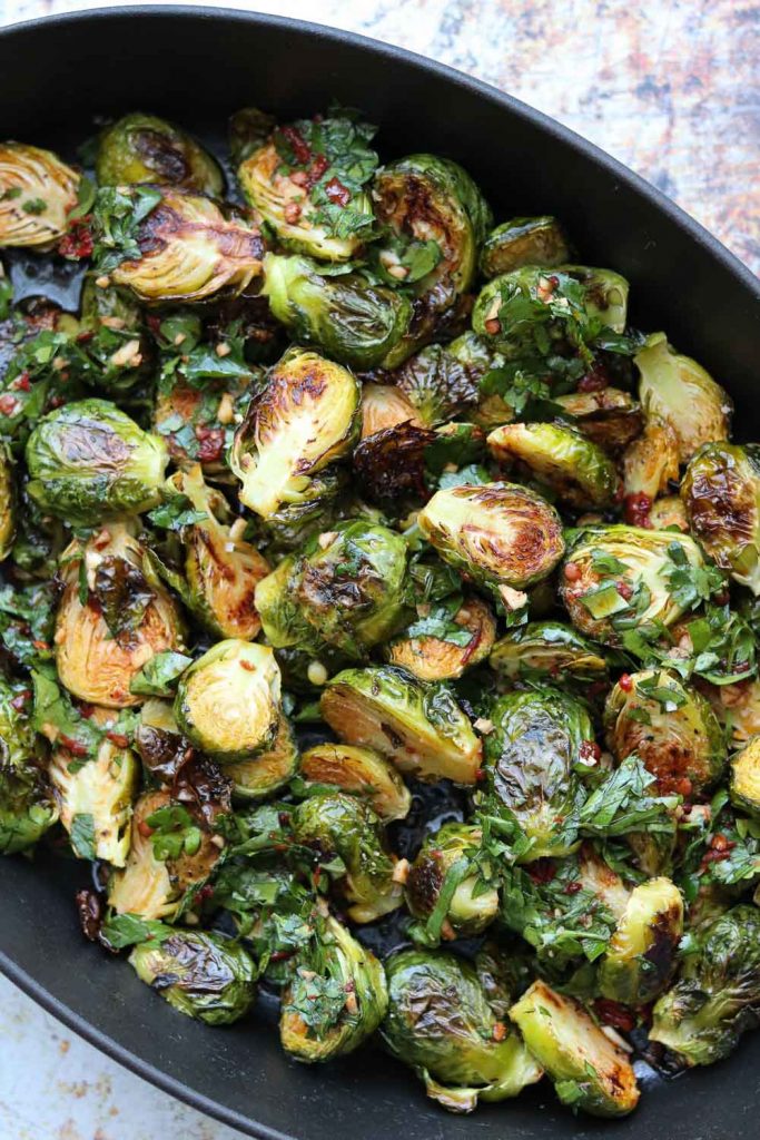 Roasted Brussels sprouts with Red Chimichurri in cast iron pan