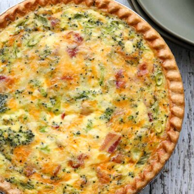 deep dish bacon and broccoli quiche with serving plates
