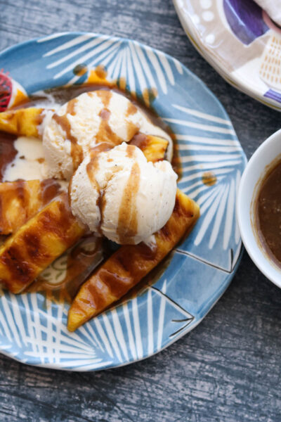 spiced rum butter sauce with ice cream and grilled pineapple on plate