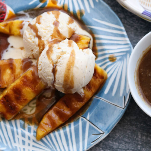 spiced rum butter sauce with ice cream and grilled pineapple on plate