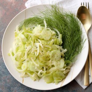 shaved fennel salad plated with fennel fronds
