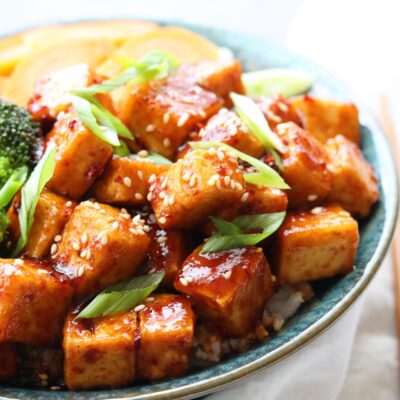 spicy korean style tofu in bowl with veggies and white napkin