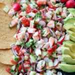 Shrimp ceviche in large platter with avocado and tostadas