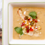 creamy potato hatch chile soup in bowl with napkin