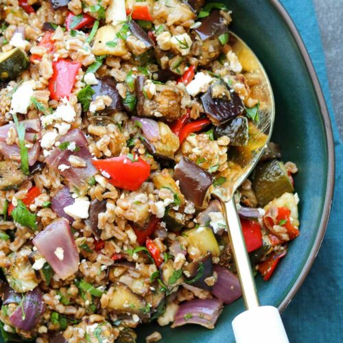 balsamic roasted vegetable grain salad with serving spoon
