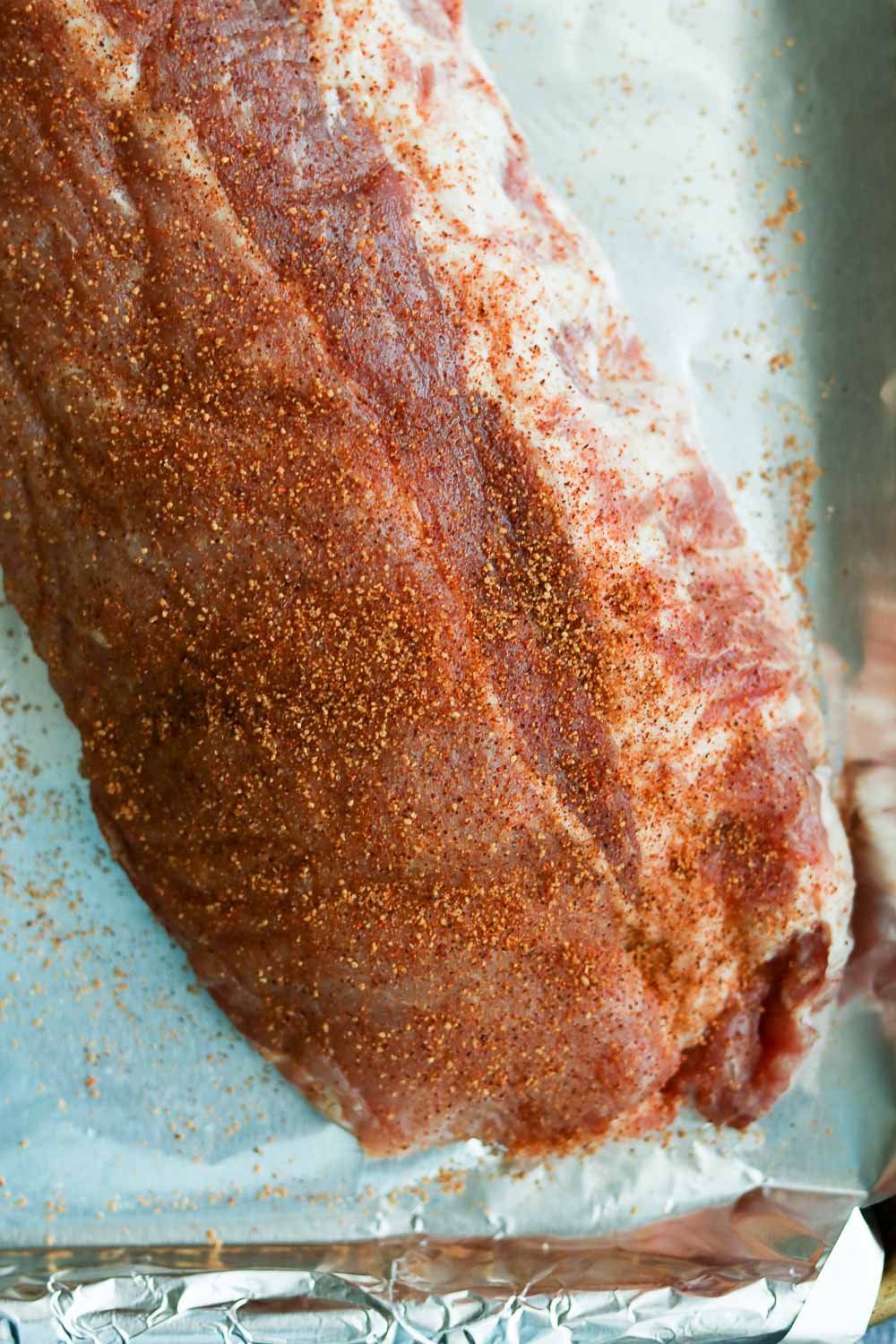 close up of raw ribs with rub