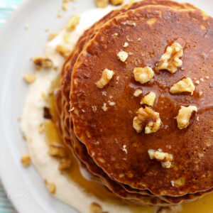 coconut carrot cake pancakes top view with walnuts on white plate