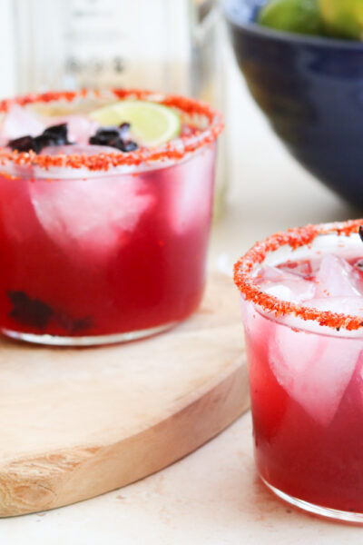 hibiscus tequila cocktails with limes in blue bowl