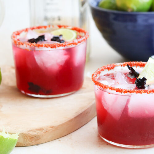 hibiscus tequila cocktails with limes in blue bowl