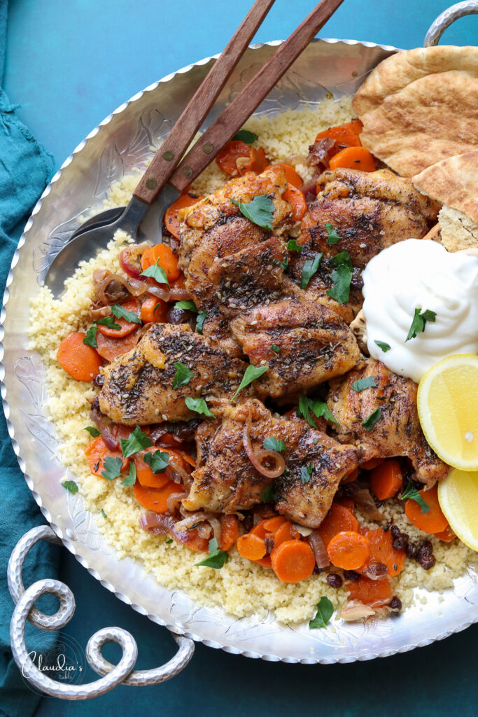 one pan chicken zaatar with carrots and currants on platter with pita, yogurt and lemon 