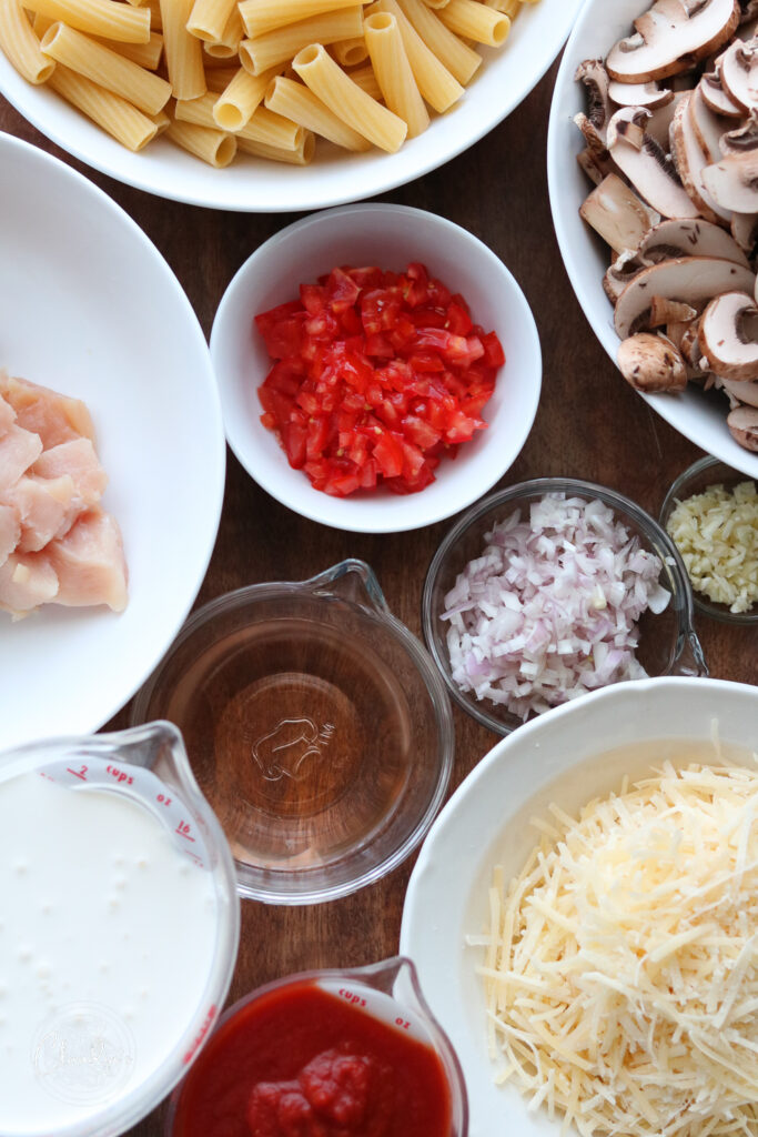 ingredients for making creamy tomato chicken and mushroom pasta 