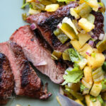 square image of steak and pineapple salsa
