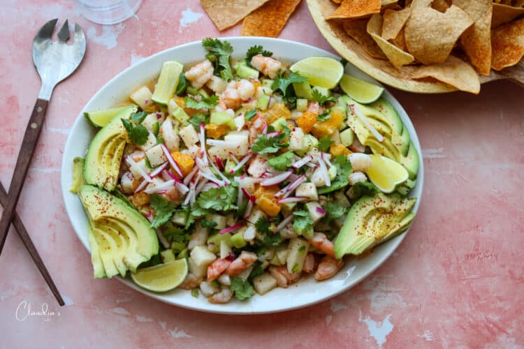 zesty shrimp avocado jicama salad on platter with tortilla chips