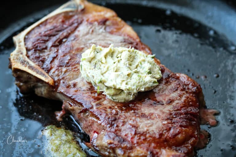 steak in cast iron skillet with compound butter