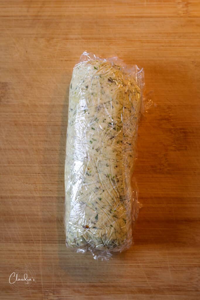 charred scallion butter wrapped in plastic wrap 