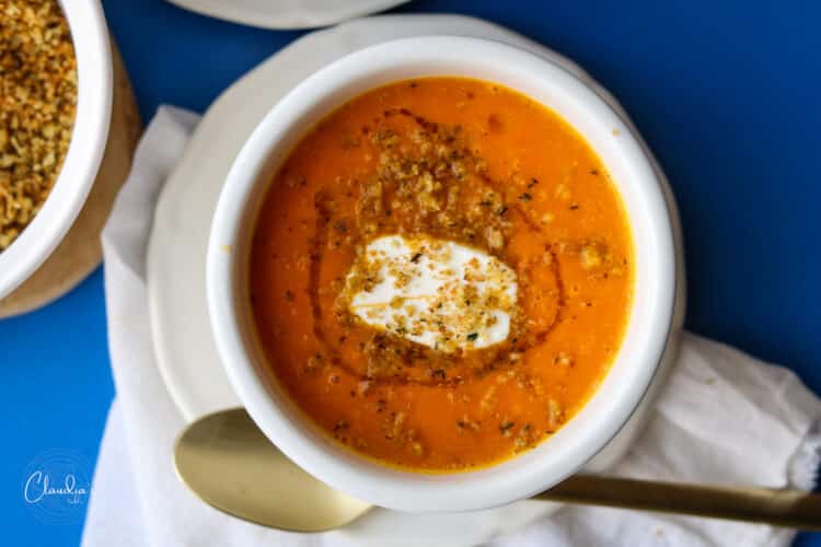 roasted carrot and sweet potato soup with spoon