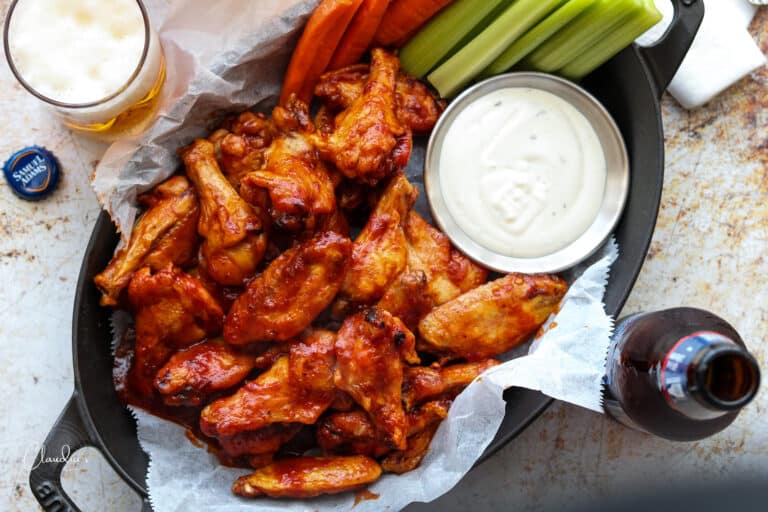baked beer bbq chicken wings with ranch dressing and beer in glasses