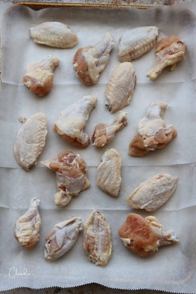 raw chicken wings on baking sheet 