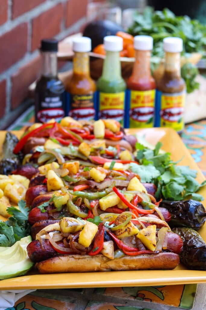 platter of LA style hot dogs with El Yucateco hot sauces 