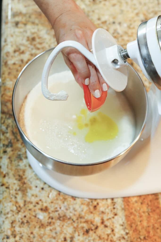 adding wet ingredients to the stand mixer