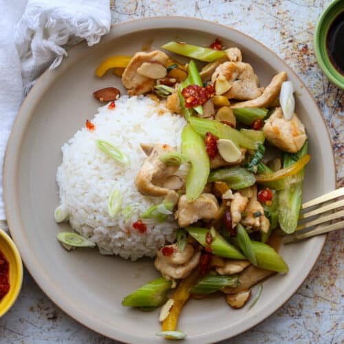easy almond stirfry with steamed rice soy and chili sauce on the sides.
