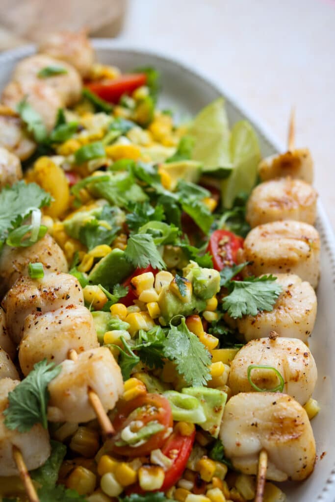 close up view of spicy scallops corn avocado and tomato salad 