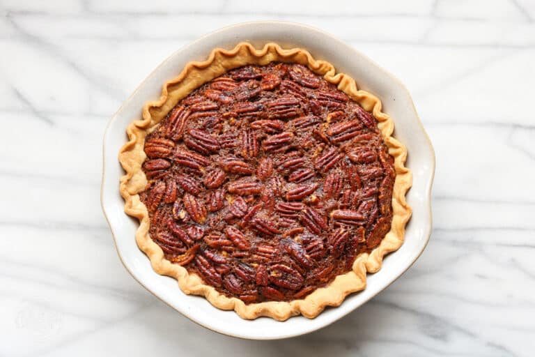 Brown Butter Bourbon Pecan Pie horizontal image on marble.