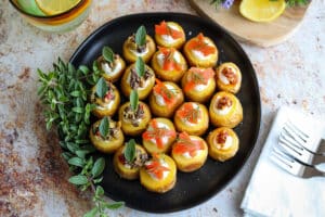 horizontal image of mini stuffed potatoes with various toppings.