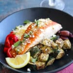 salmon with lemon garlic sauce, zucchini, couscous, red peppers and olives