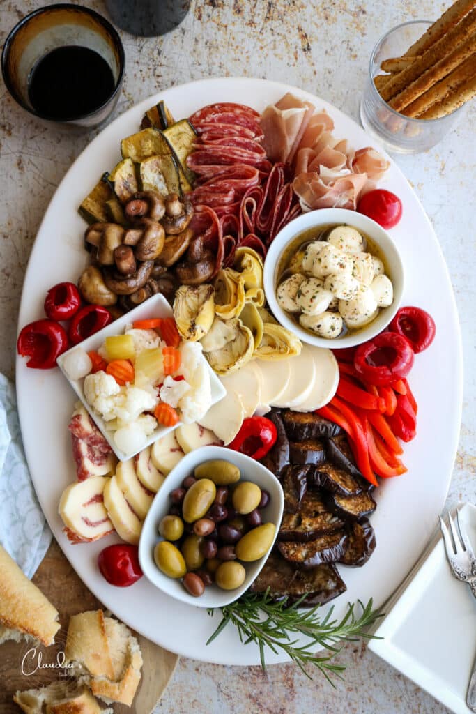The ultimate antipasto platter with breadsticks and wine 