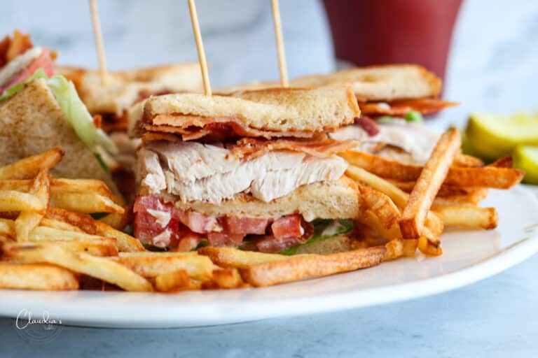 close up of classic turkey club with french fries