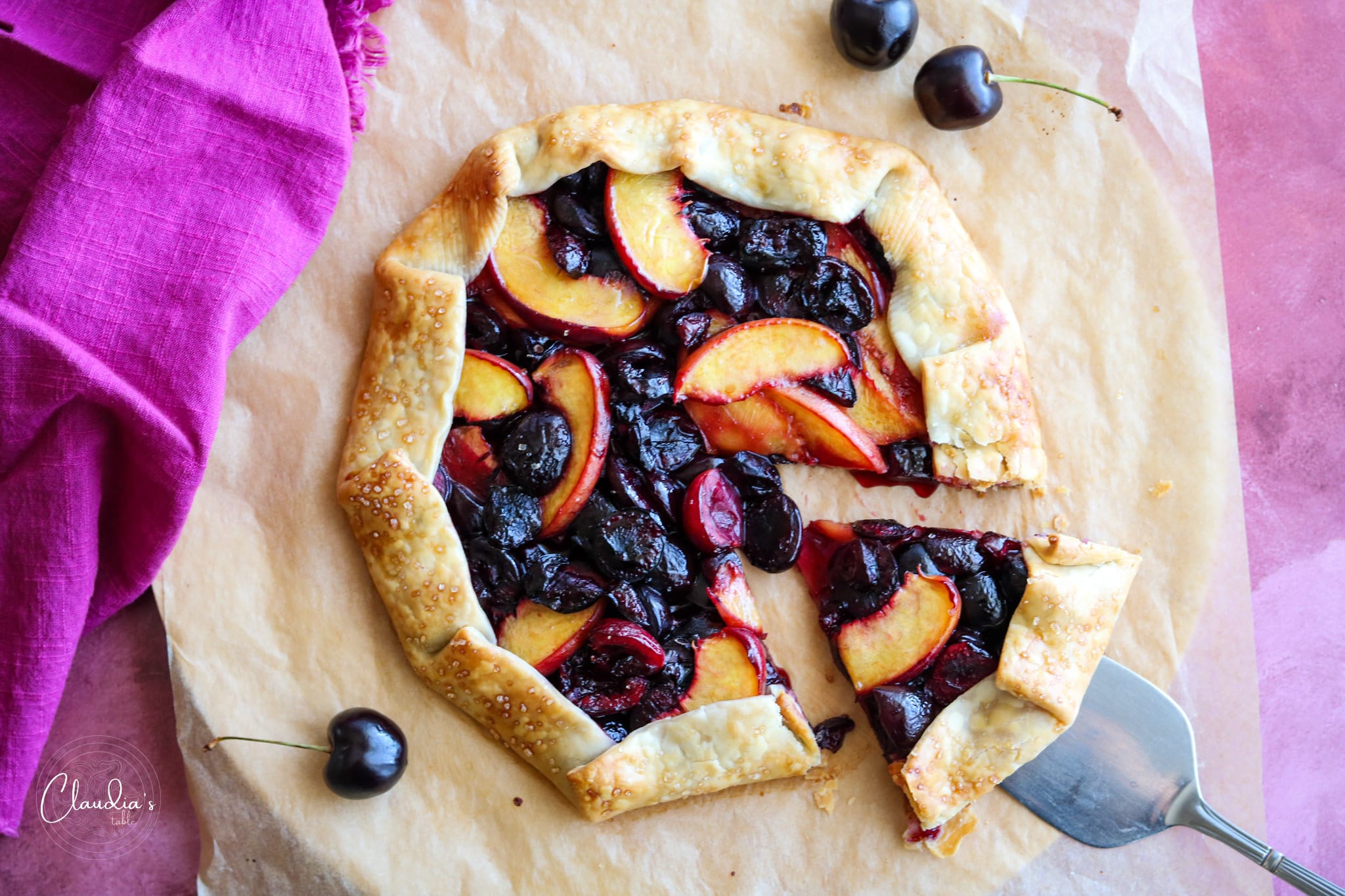 cherry and peach galette on wood board