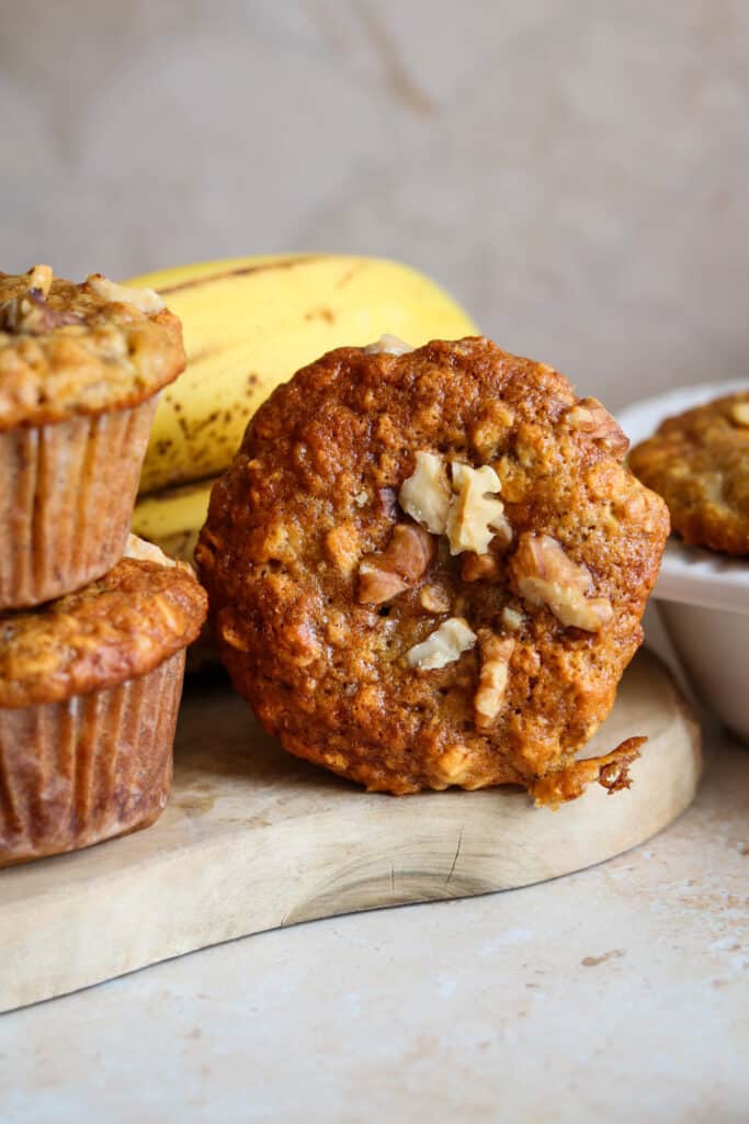 banana and oat muffin with walnuts on wood board 