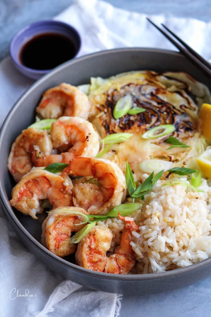 Miso butter shrimp served with charred cabbage and steamed rice.