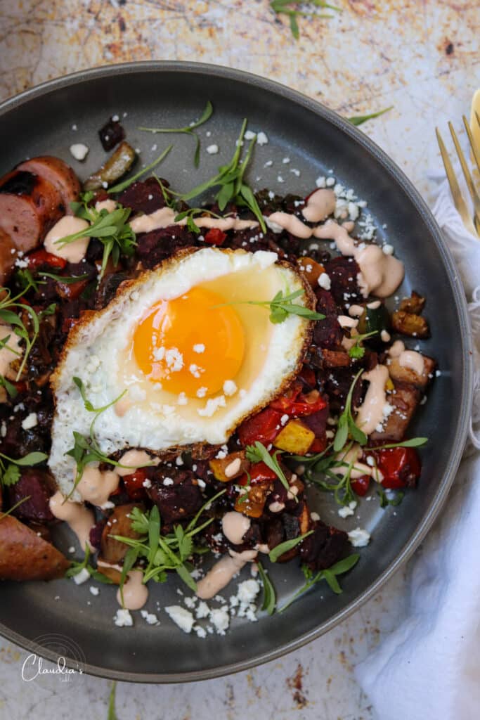 Vegetable breakfast has with sweet potatoes with egg over easy.