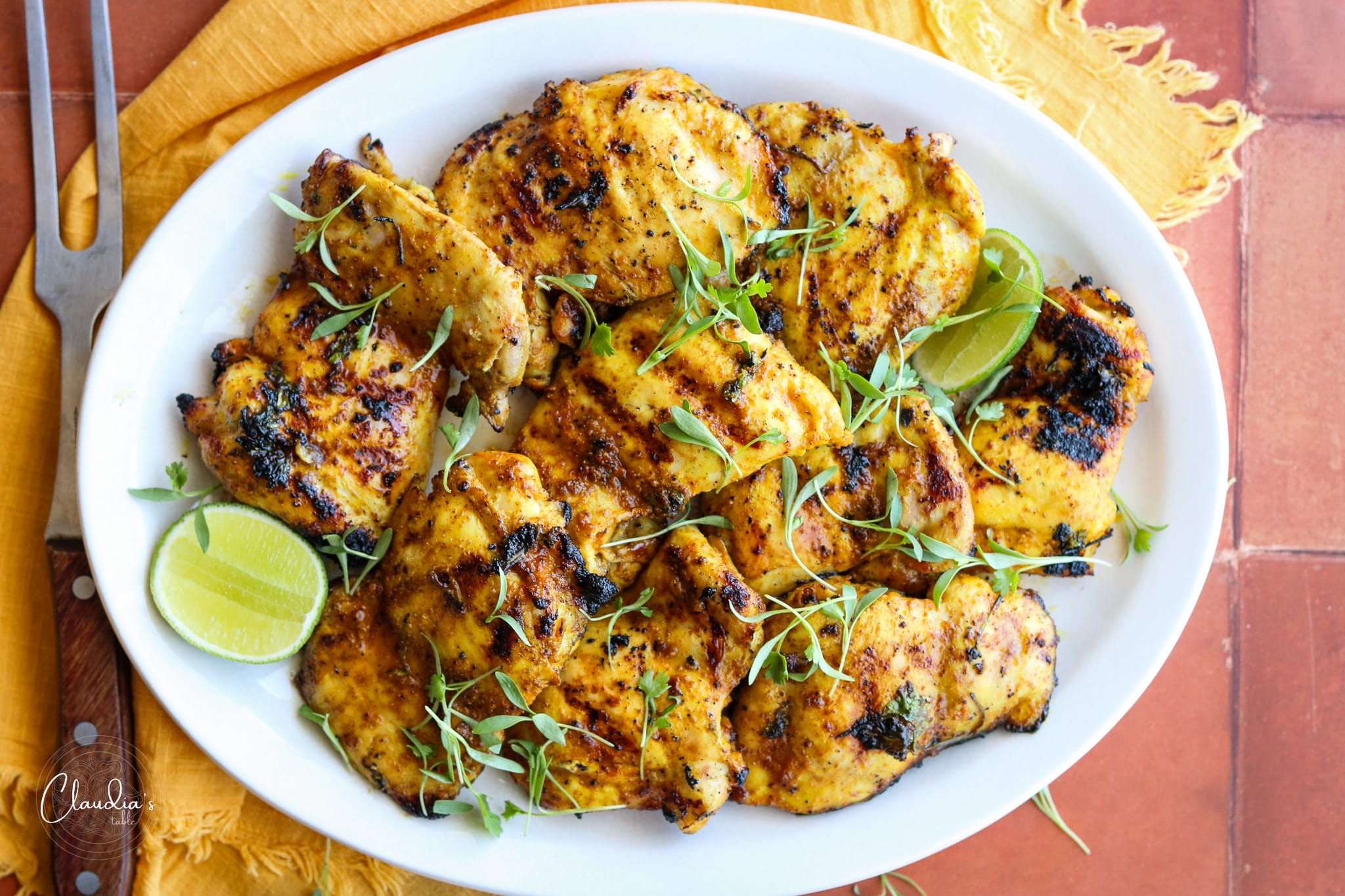 Citrus marinated chicken thighs with lime wedges