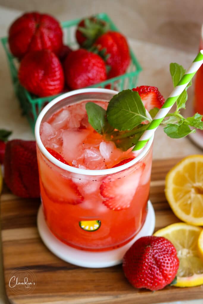 strawberry lemonade garnished with fresh mint on board