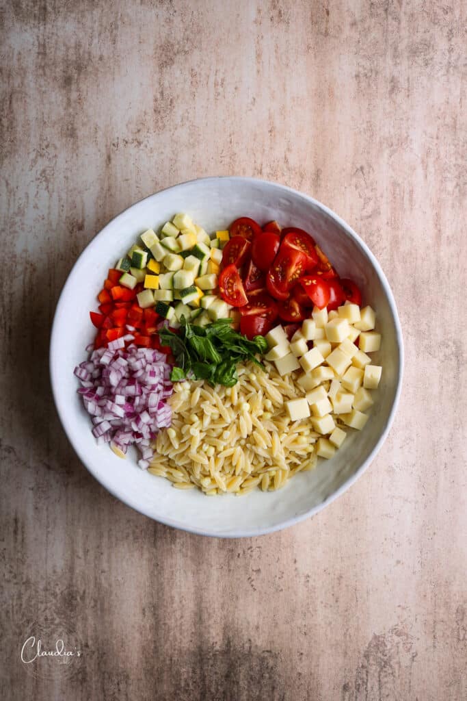 Assembling the salad. Ingredients in white bowl. 