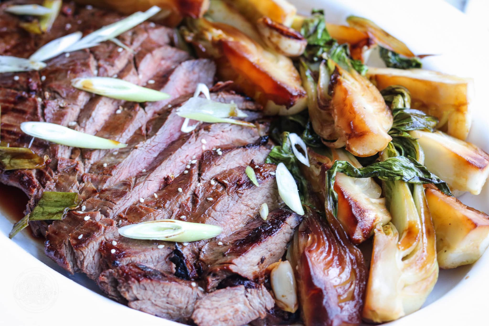 grilled flank steak with Asian flavors served with bok choy