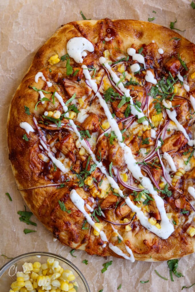 BBQ chicken pizza top view closeup with ranch dressing drizzle 