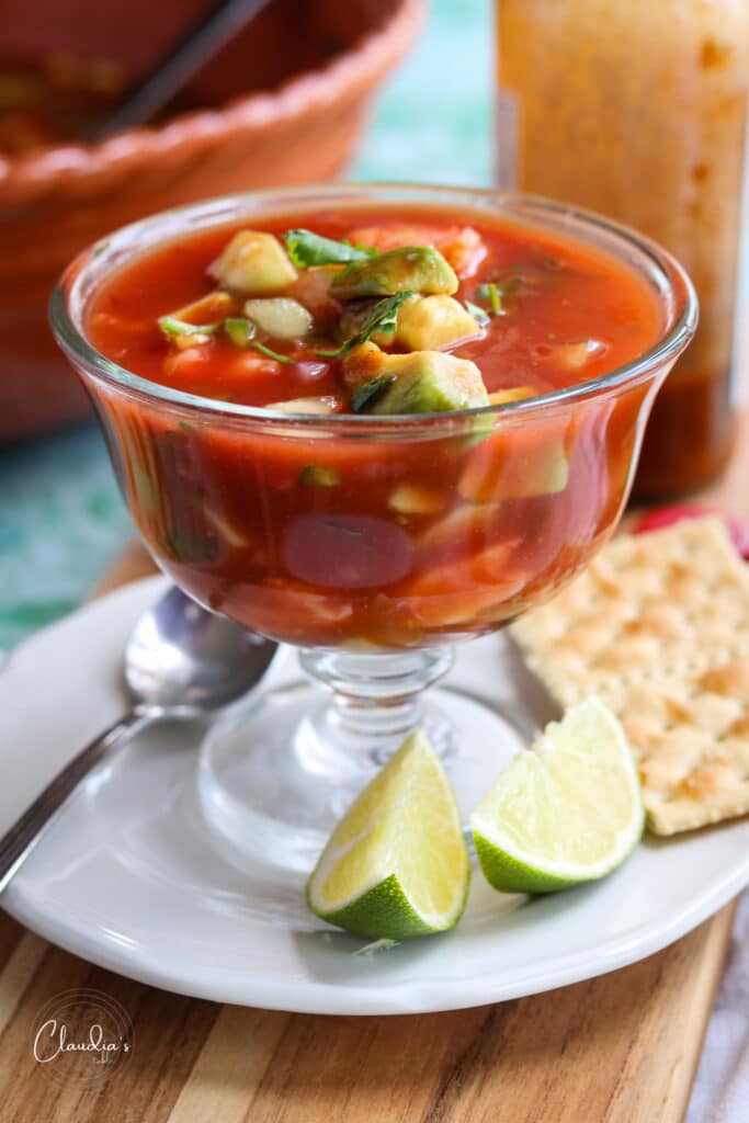 close up of Easy Mexican Shrimp Cocktail with saltine crackers and lime wedges