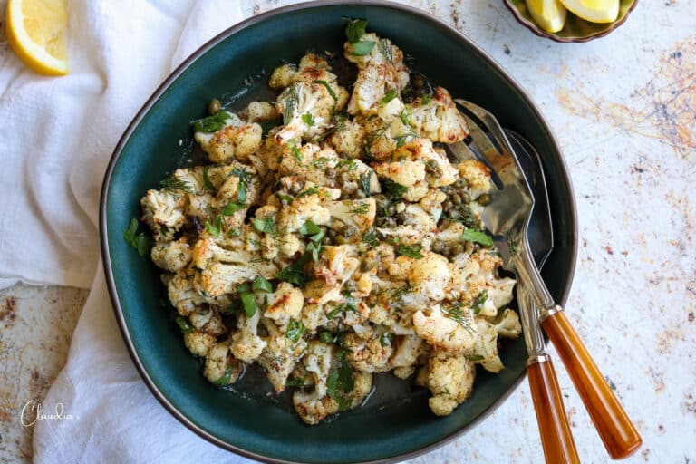 roasted cauliflower salad with fresh herbs in green bowl