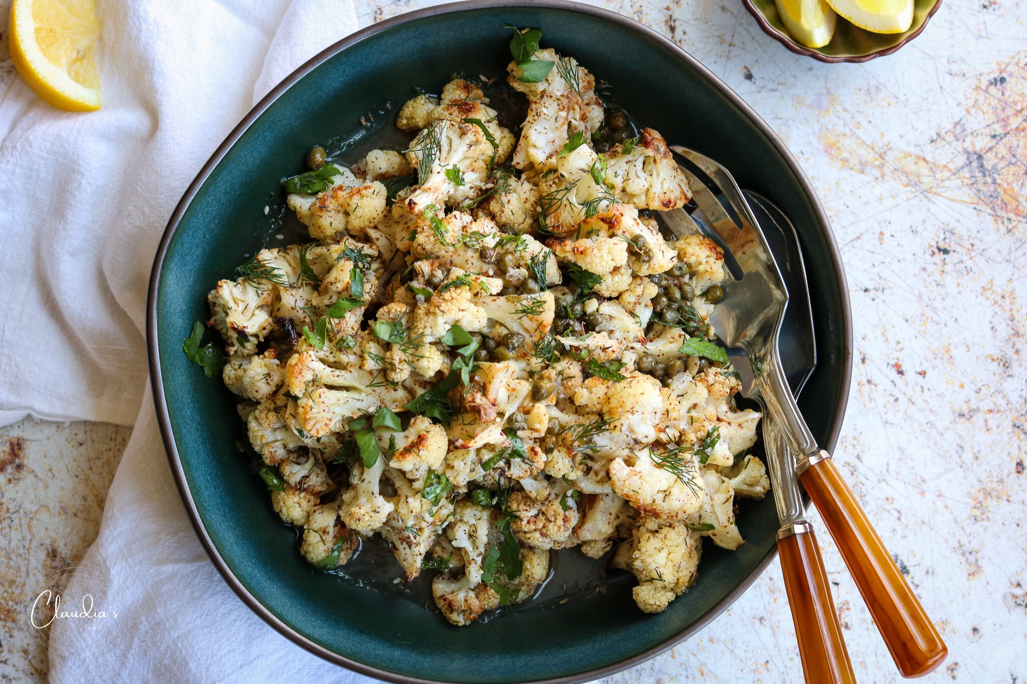 roasted cauliflower salad with fresh herbs in green bowl