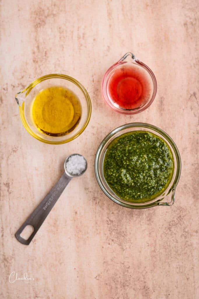 ingredients for pesto vinaigrette in small glass bowls